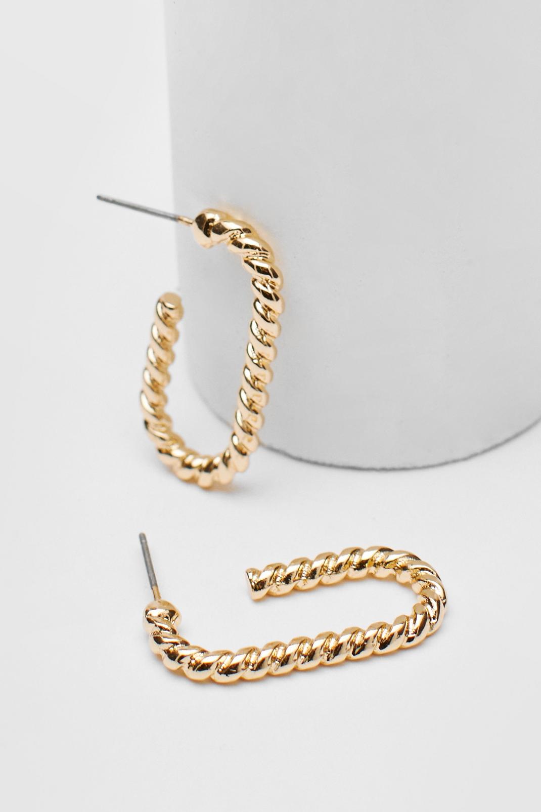 Gold Twisted Oval Hoop Earrings image number 1