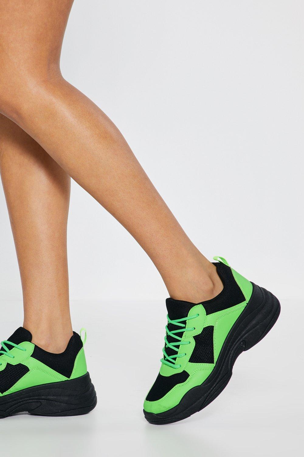 neon green and black trainers