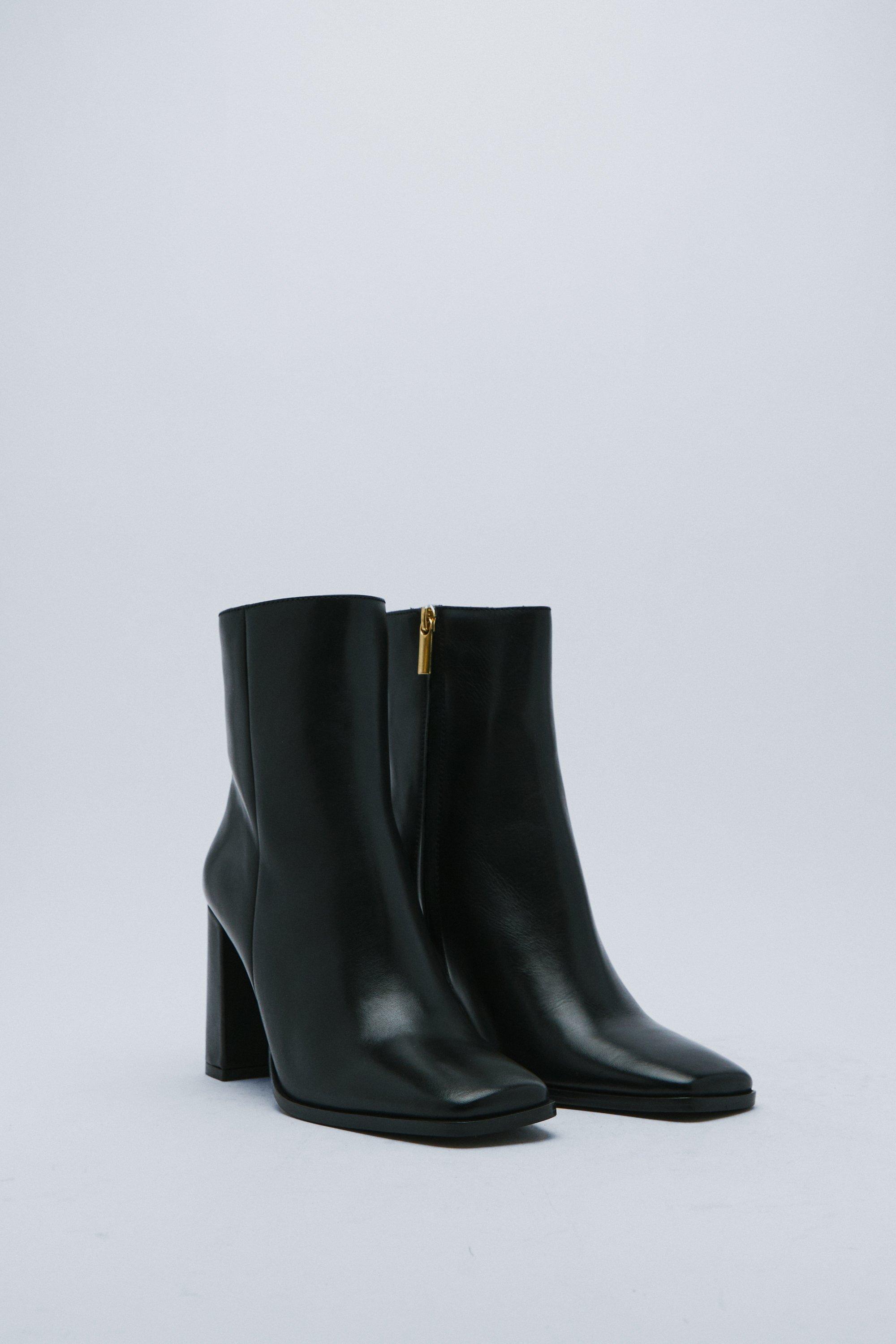 Black ankle boots with rectangular heel and square toe with gold detail